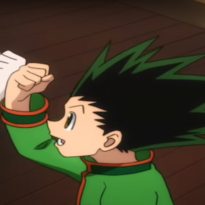 Gon fist bumping Killua and smiling