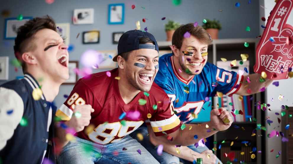 Friends watching football at party